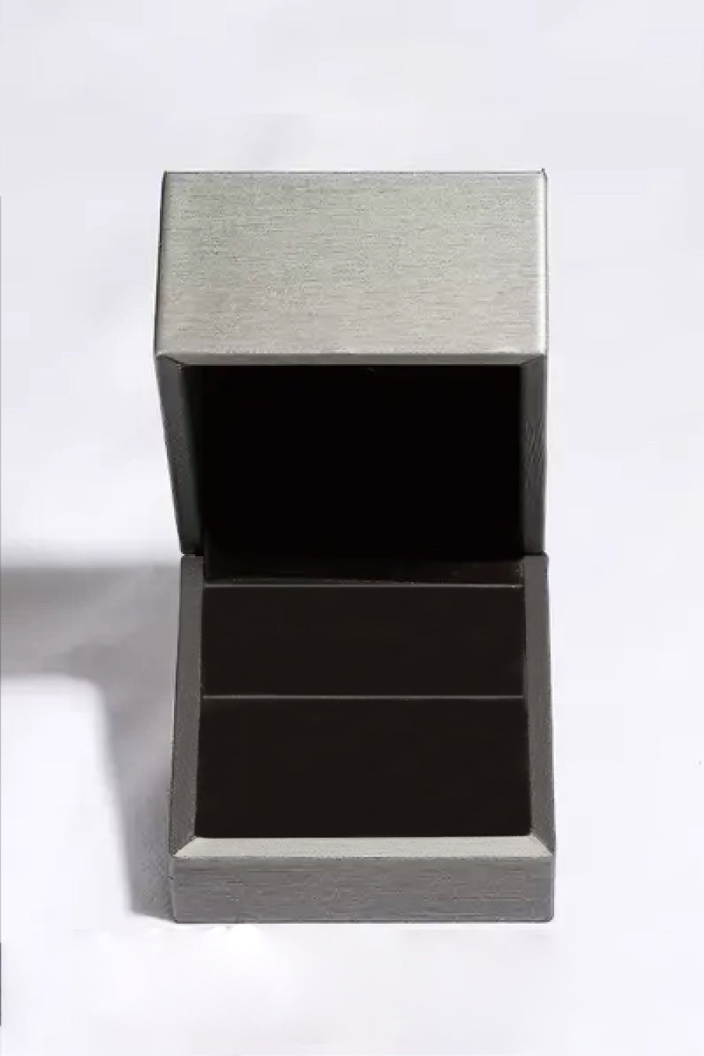 Stainless steel and black jewelry display box, showcasing a 1 Carat Moissanite 925 Sterling Silver Crown Ring.