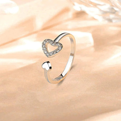 a silver ring with a heart on it