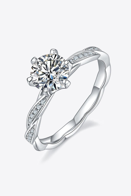 Elegant sterling silver ring with sparkling moissanite center stone and delicate diamond accents.