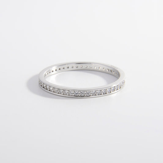 a white gold ring with a row of diamonds