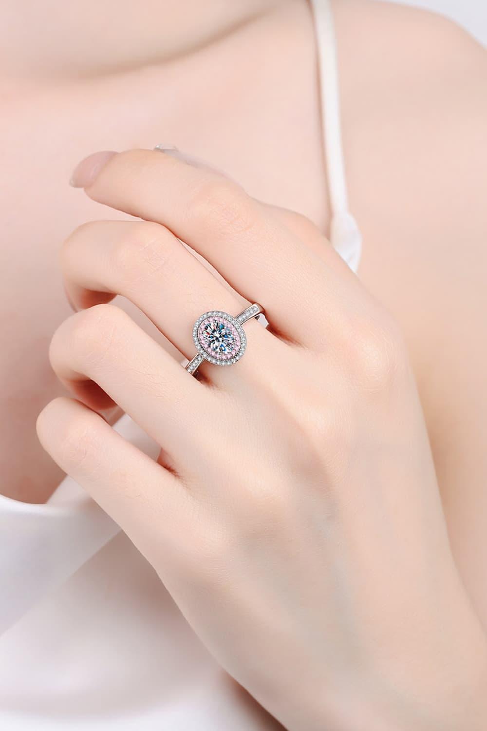 Elegant sterling silver halo ring with shimmering moissanite center stone, showcasing a luxurious yet feminine design.