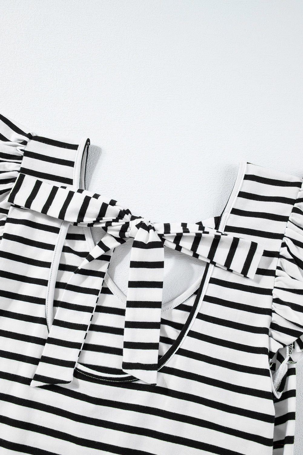 a black and white striped shirt with ruffles