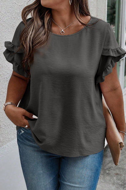 a woman wearing a grey top and jeans