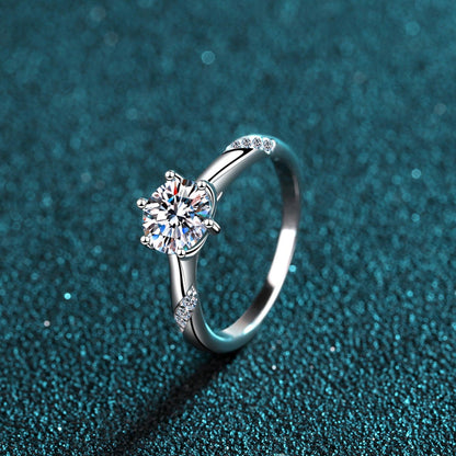 Elegant diamond engagement ring set on a sparkling teal background