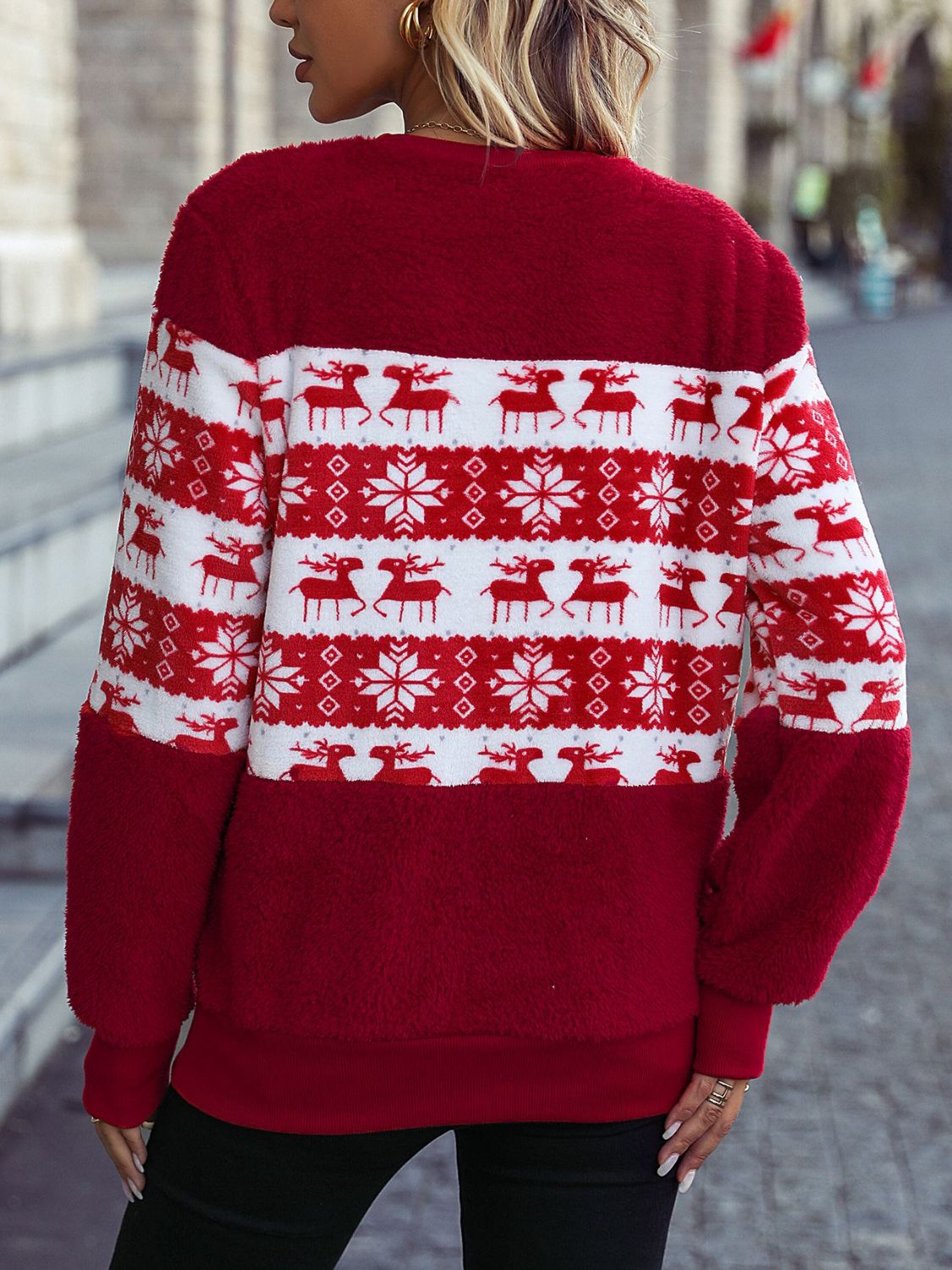 a woman wearing a red and white christmas sweater