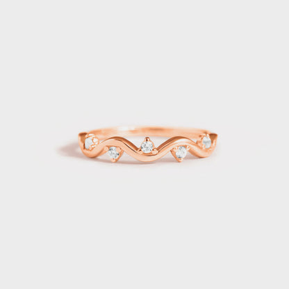 a rose gold ring with three diamonds