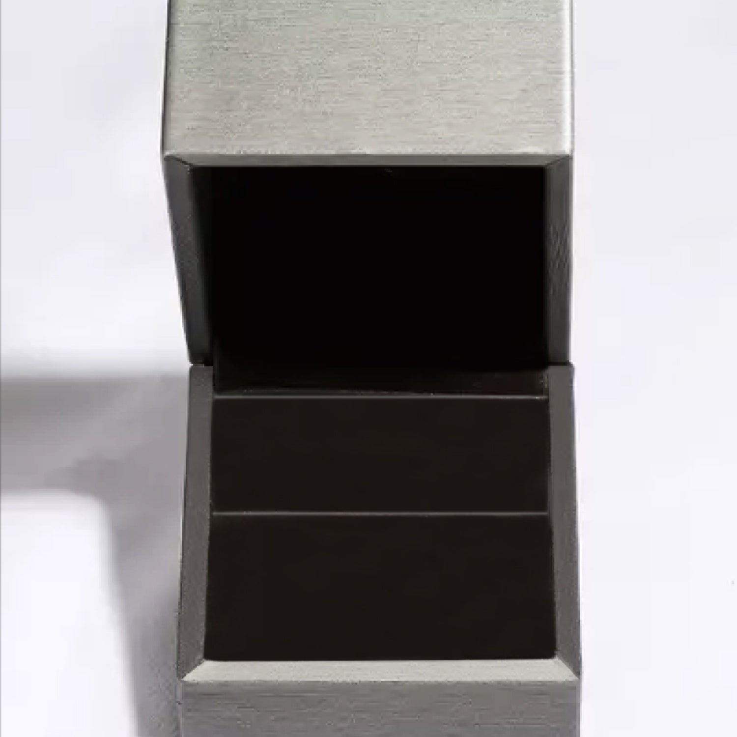 Rectangular stainless steel jewelry box with an open lid revealing a black interior