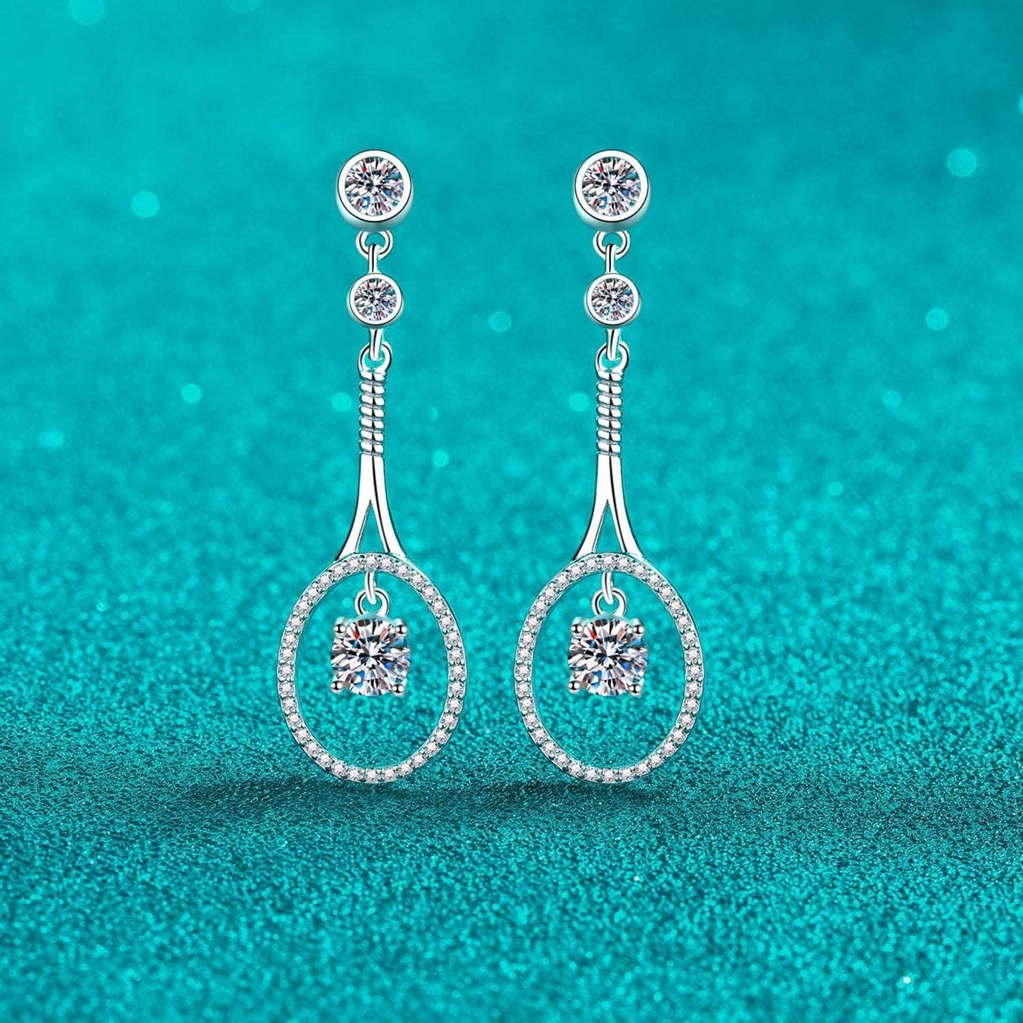 Elegant 1 Carat Moissanite Sterling Silver Drop Earrings on a vibrant turquoise background