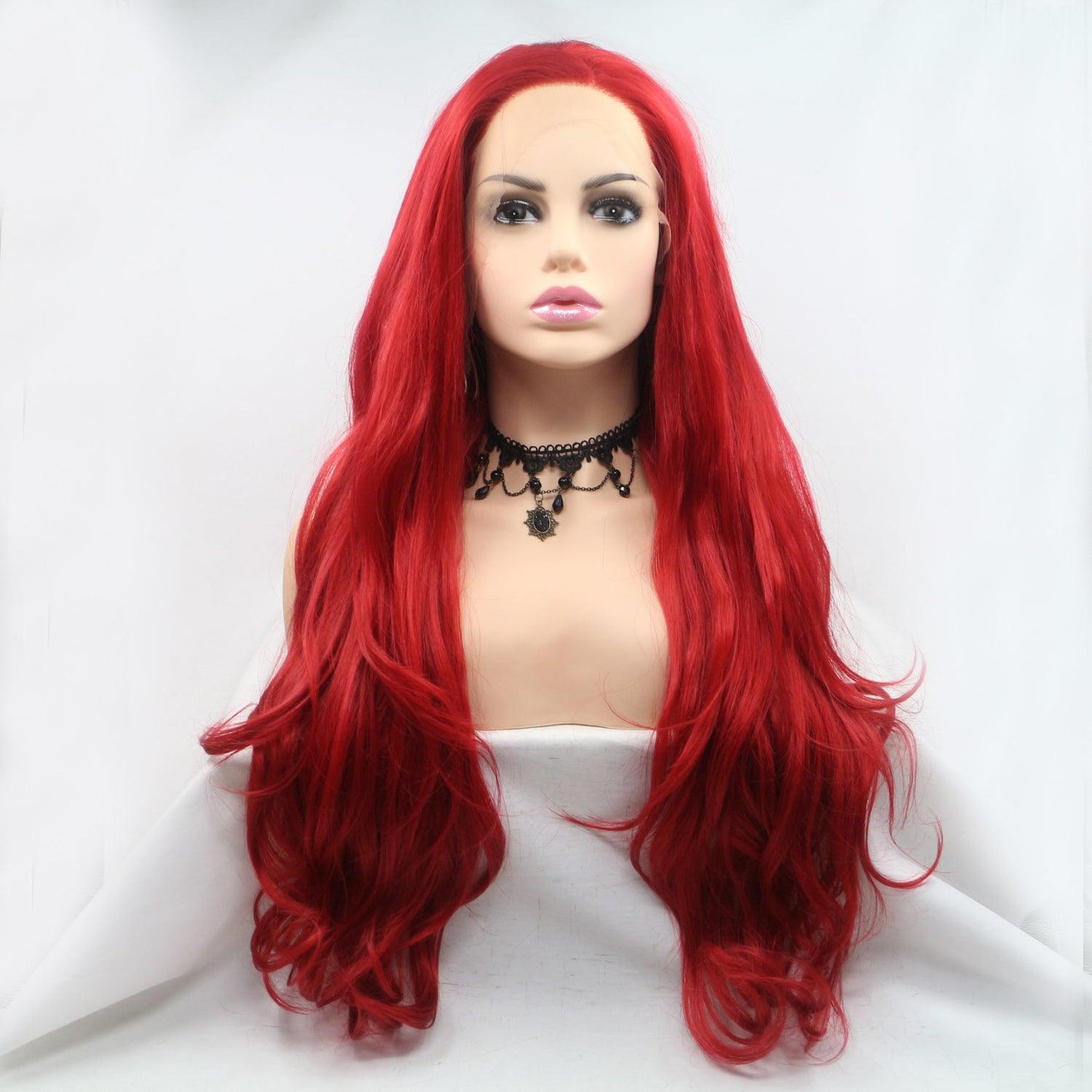 Long, wavy red synthetic wig with 130% density showcased on a display model.