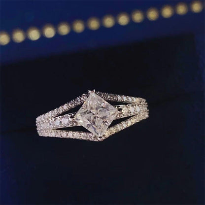 Elegant moissanite engagement ring with intricate details on a dark background