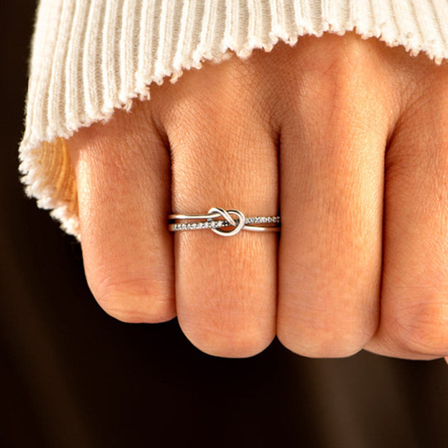 a woman's hand with a ring on it