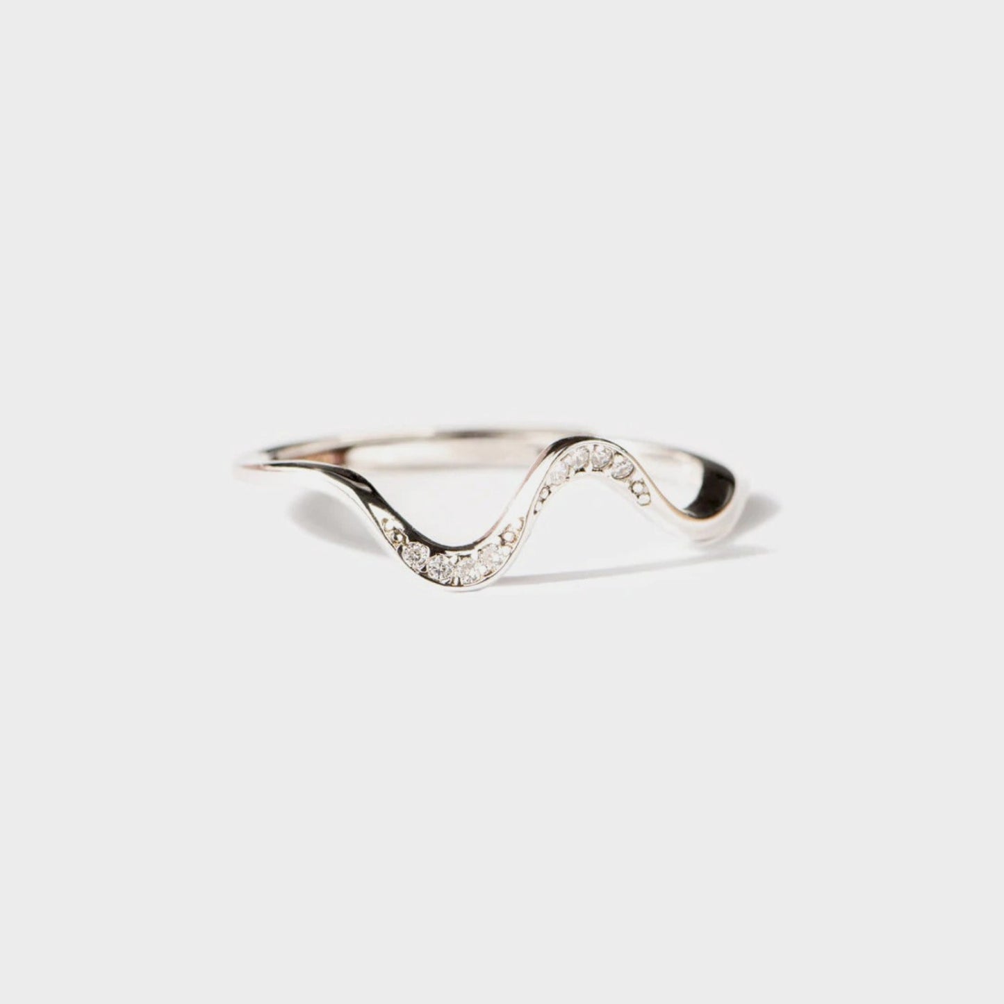 a white gold ring with a wave design