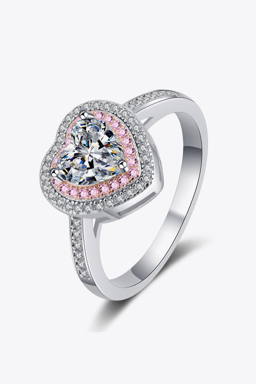 Elegant heart-shaped moissanite engagement ring with sparkling pink and white accents, set in sleek sterling silver band