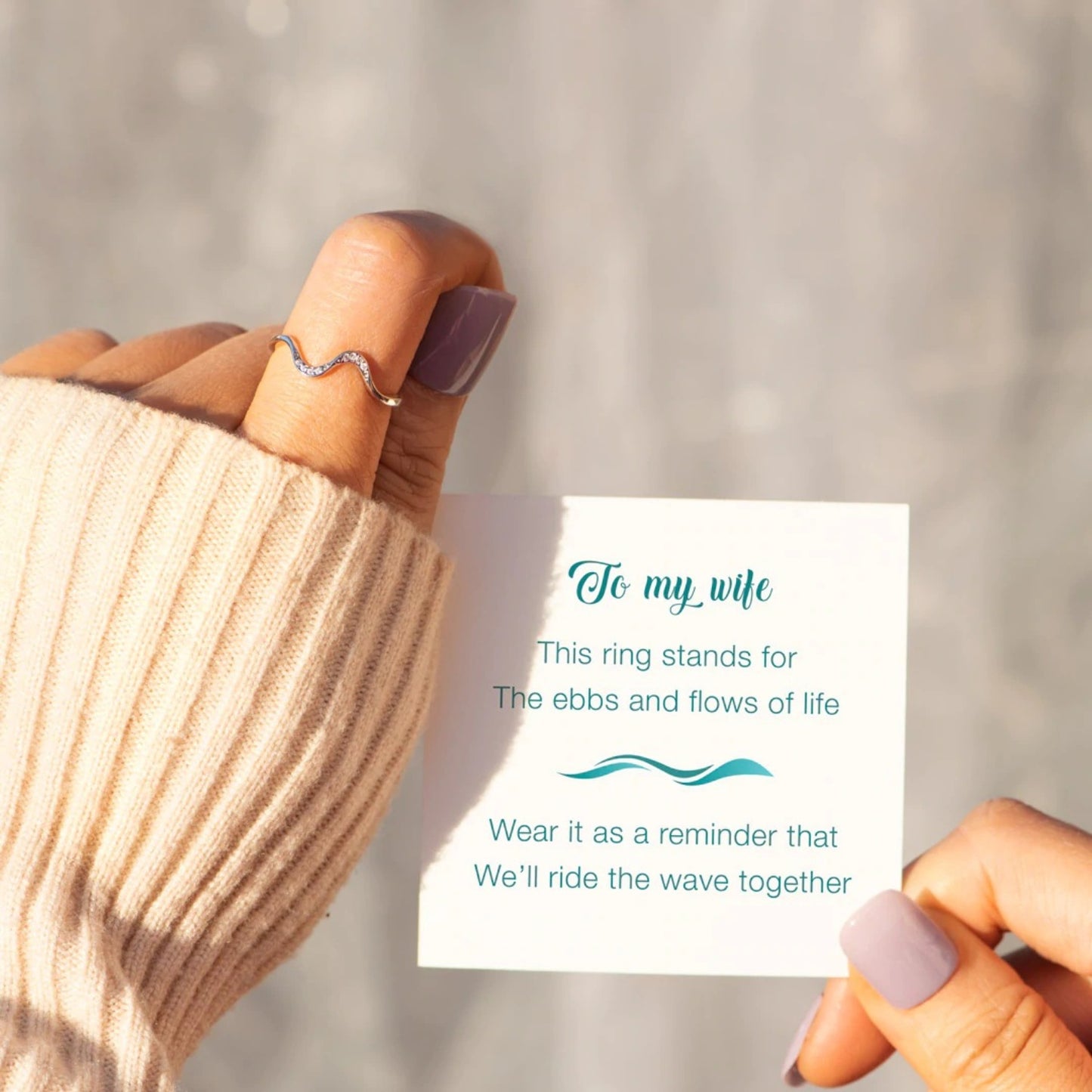 a person holding a piece of paper with a ring on it