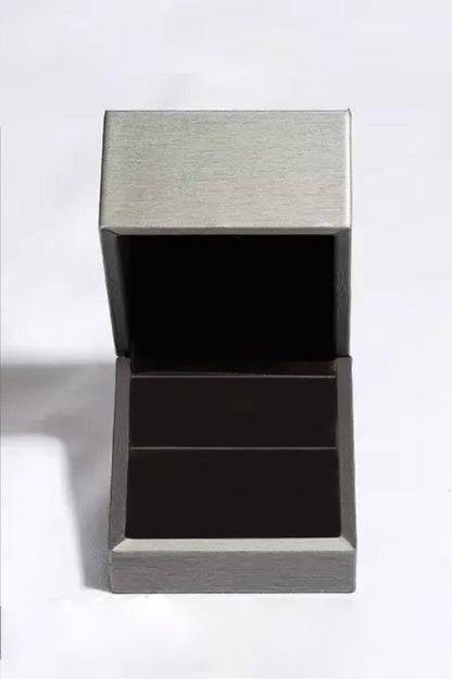 Sleek Stainless Steel and Black Jewelry Box - Modern, minimalist design with a brushed metal lid and dark interior compartments to showcase premium 1 Carat Moissanite 925 Sterling Silver Stud Earrings.