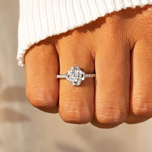 a woman's hand with a diamond ring on it