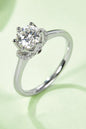 Stunning 1 Carat Moissanite Solitaire Ring on Green Background