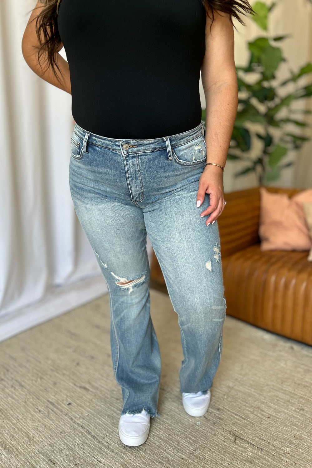 a woman standing in a room with her hands on her hips