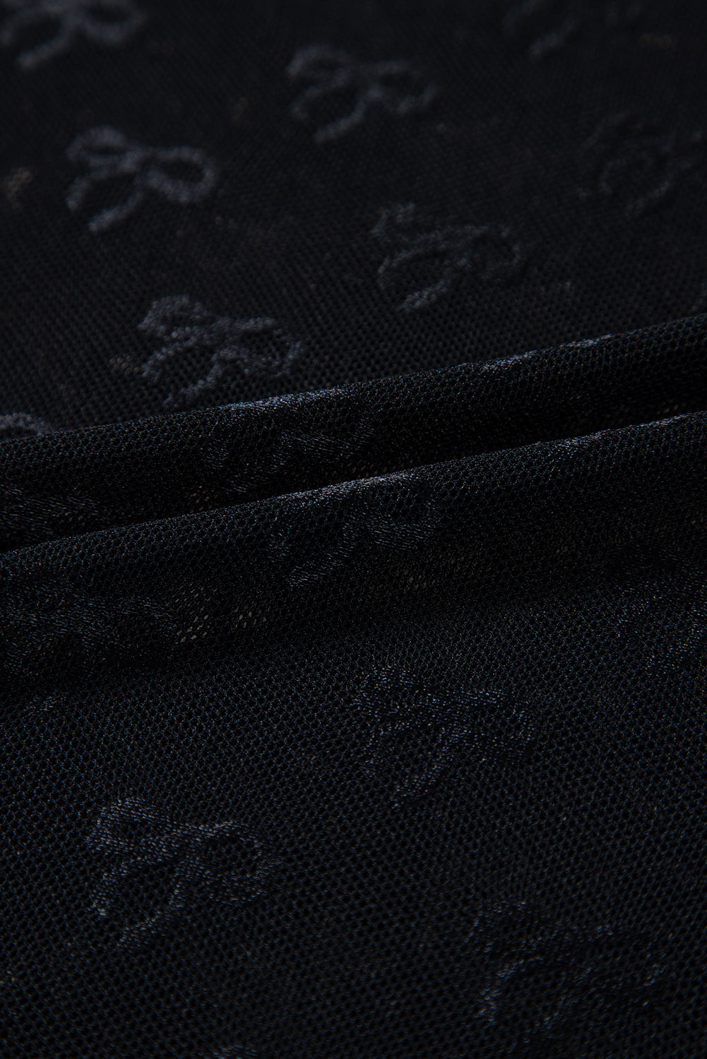 a close up of a black cloth with a pattern on it