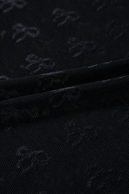 a close up of a black cloth with a pattern on it