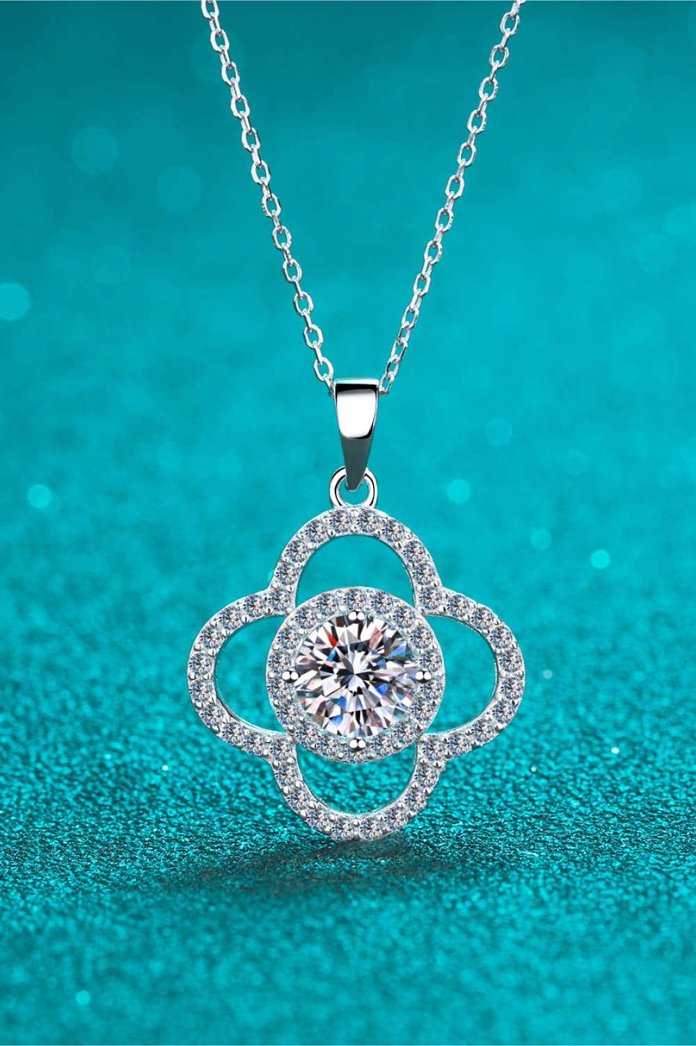 Elegant 1 Carat Moissanite Pendant Necklace in 925 Sterling Silver on Turquoise Background