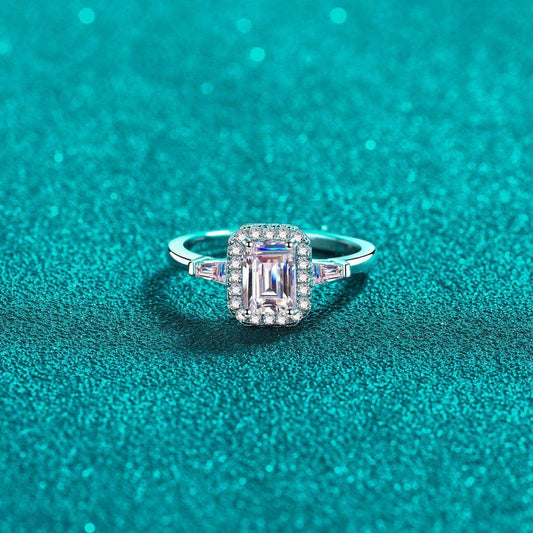 Sparkling 1 Carat Moissanite 925 Sterling Silver Ring on Teal Glitter Background