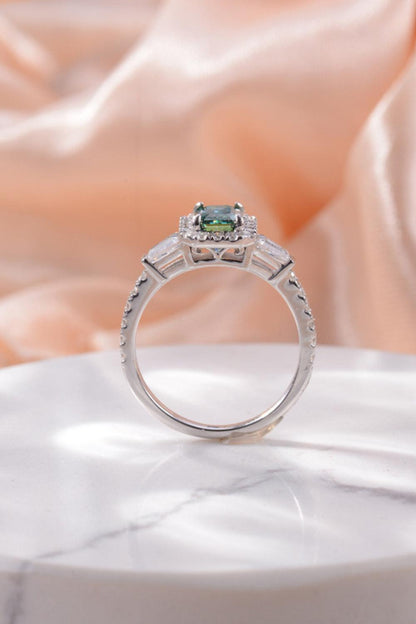 Elegant 1 Carat Moissanite 925 Sterling Silver Ring with sparkling halo and solitaire design showcased on a soft, shimmering backdrop.