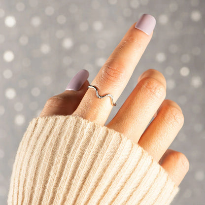 a woman's hand with a ring on it