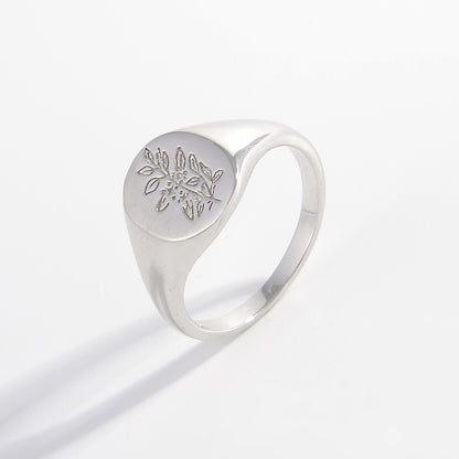 a silver ring with a flower on it