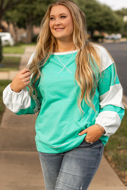 a woman standing on a sidewalk with her hands in her pockets