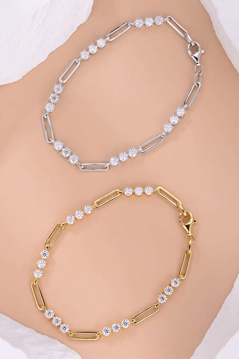 Stylish sterling silver and gold-toned crystal-embellished bracelets displayed on a woman's arm in this close-up product image.