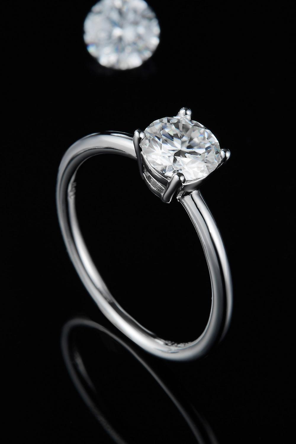 Elegant solitaire engagement ring with brilliant diamond on dark background