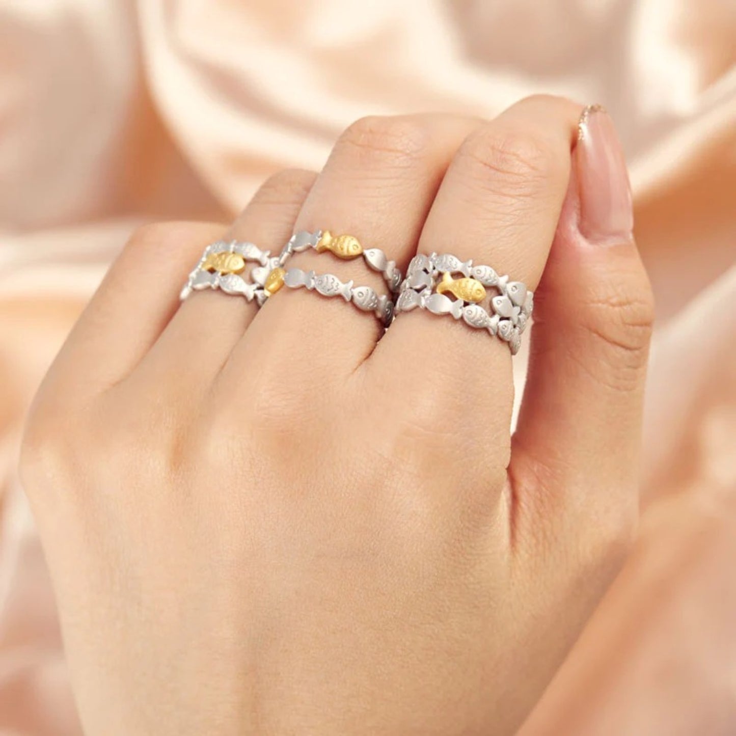 a woman's hand with two rings on it