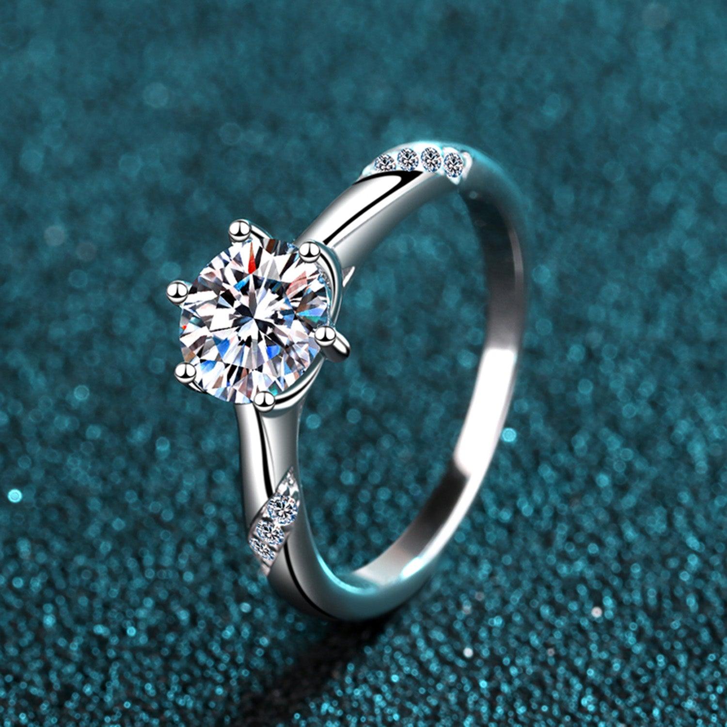 Elegant Moissanite 925 Sterling Silver Engagement Ring on Sparkling Teal Background