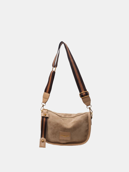 a beige bag with a brown strap on a white background