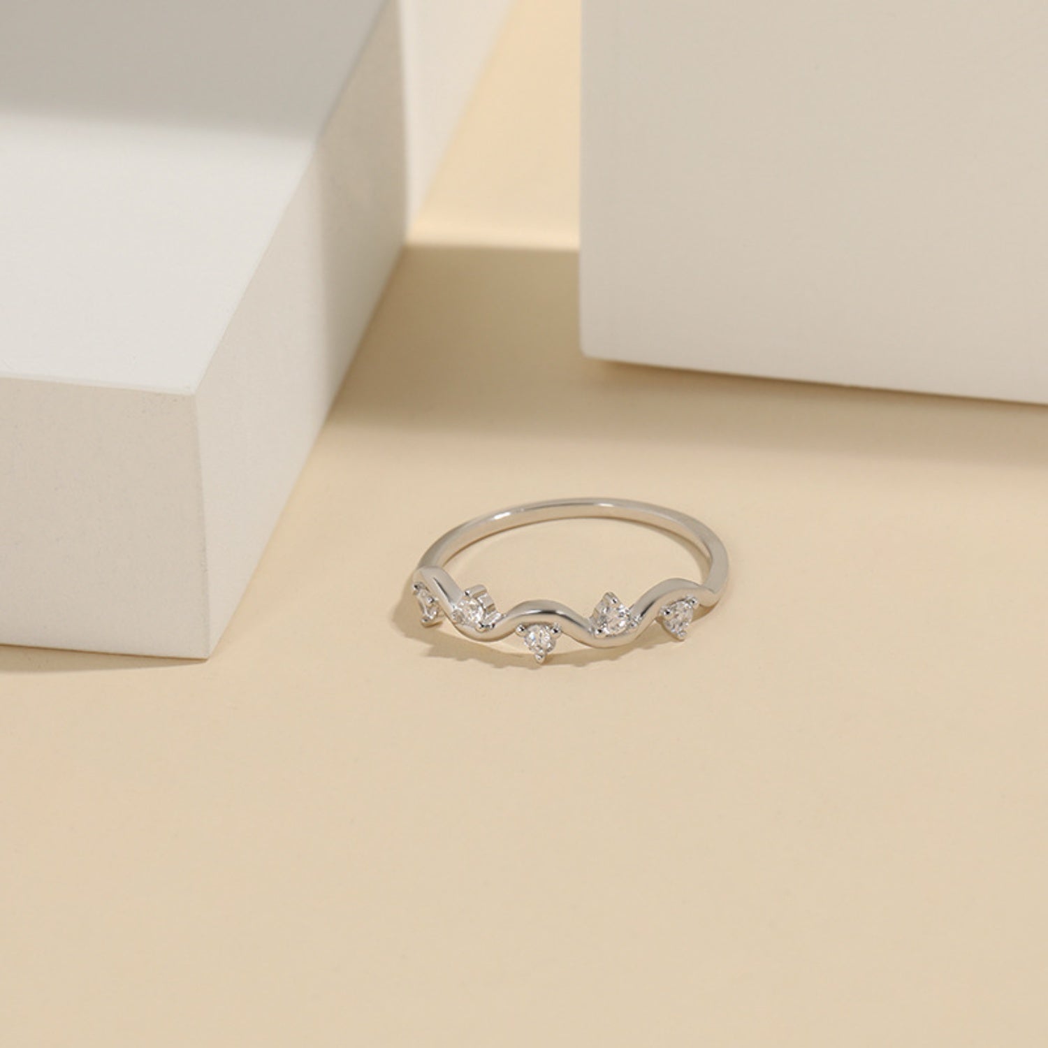 a diamond ring sits on a table next to a white box