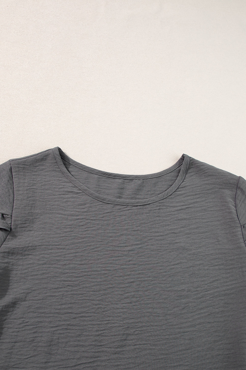 a close up of a gray shirt on a white background