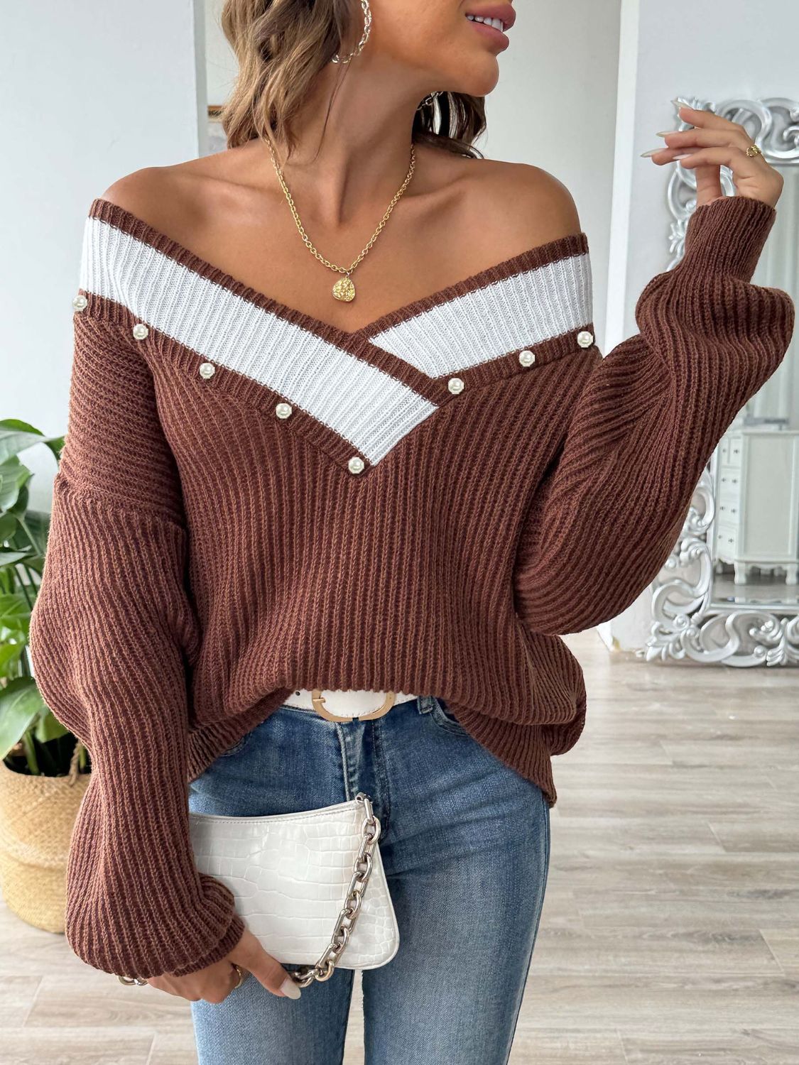 a woman wearing a brown and white sweater