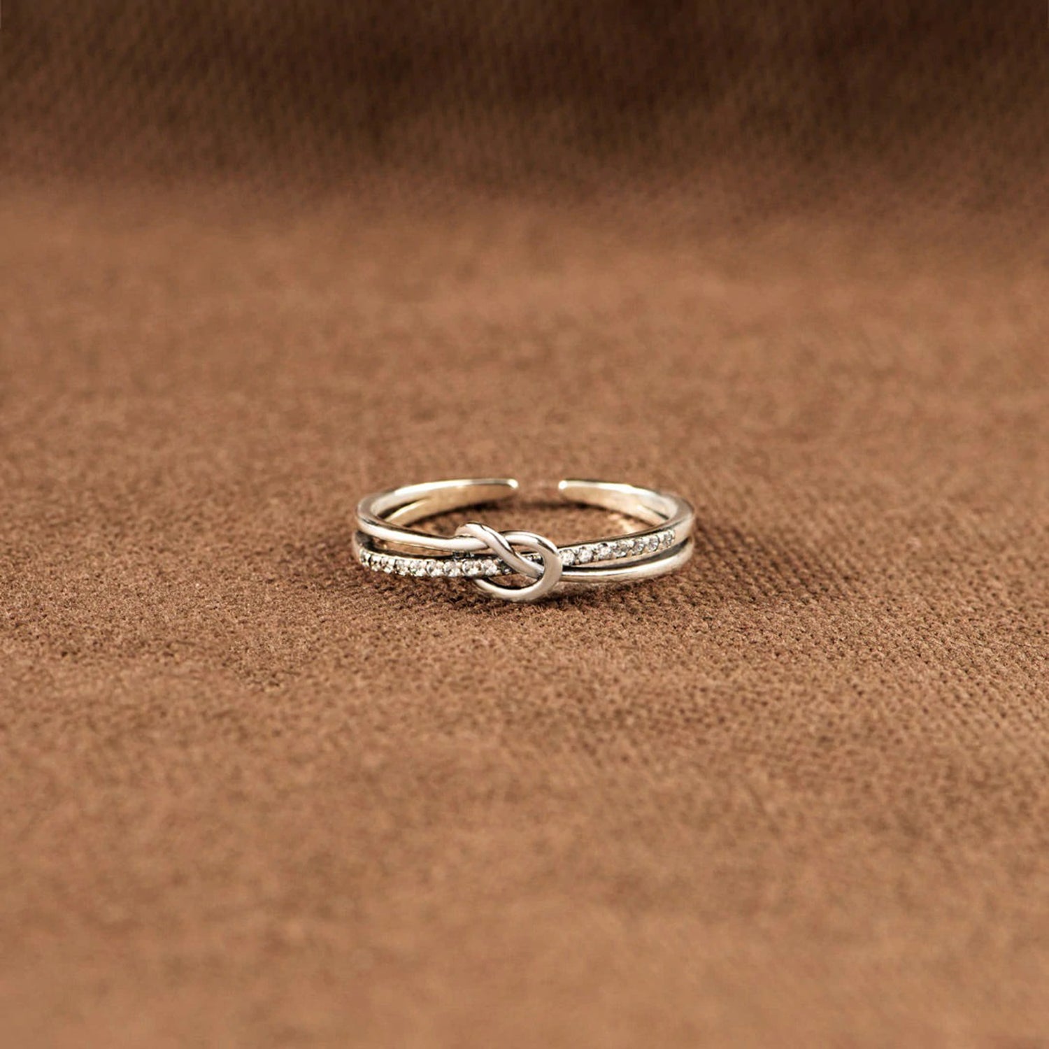 a couple of rings sitting on top of a brown cloth