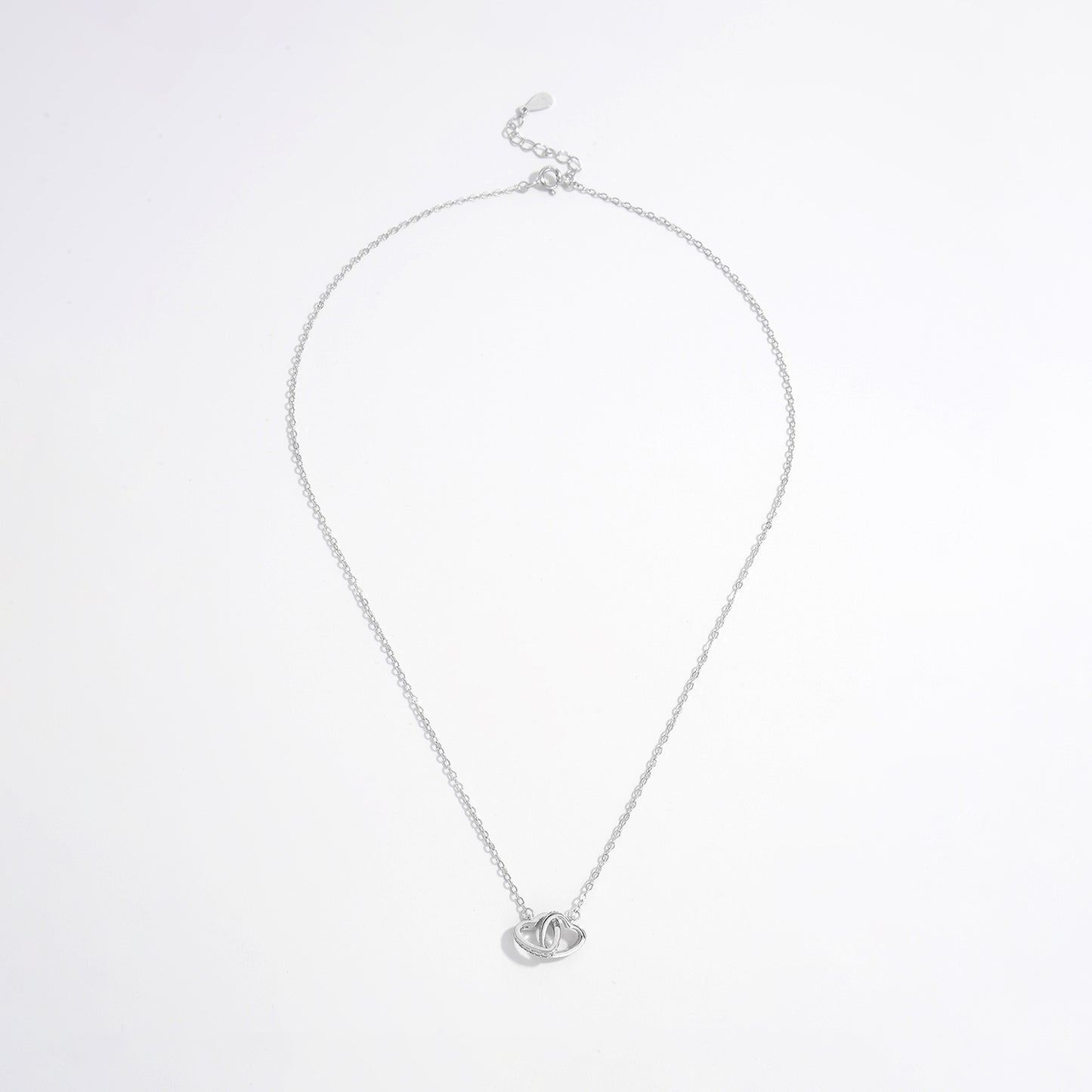 a silver necklace with a heart on it