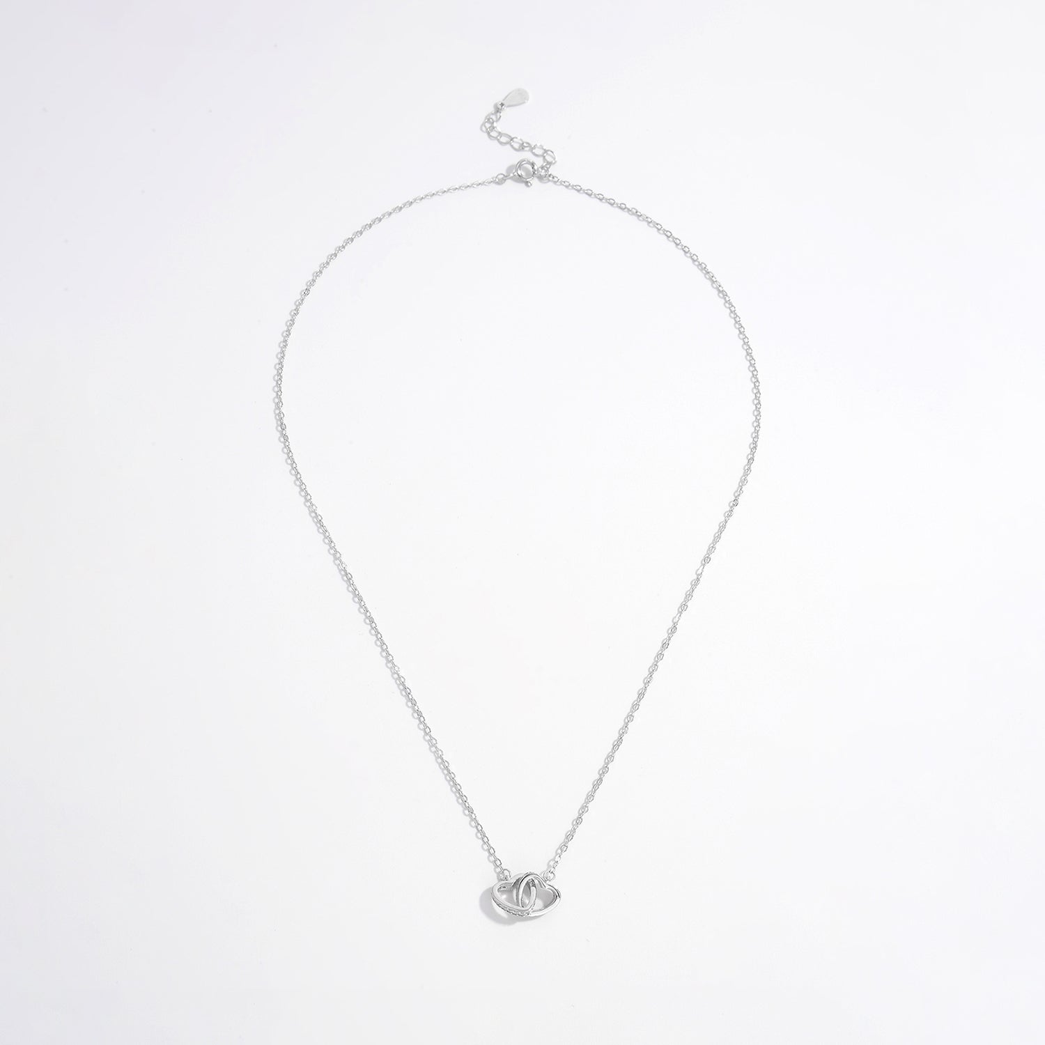 a silver necklace with a heart on it