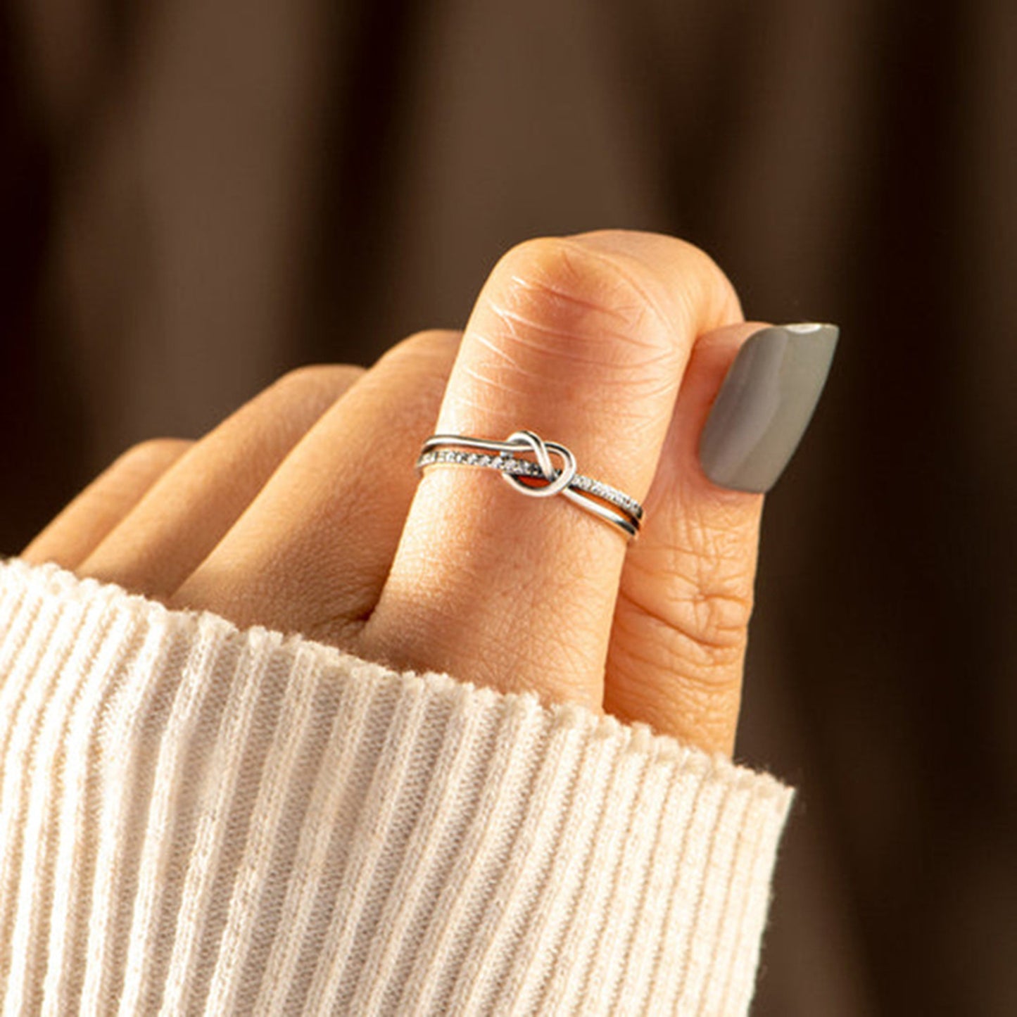 a woman's hand with a ring on it