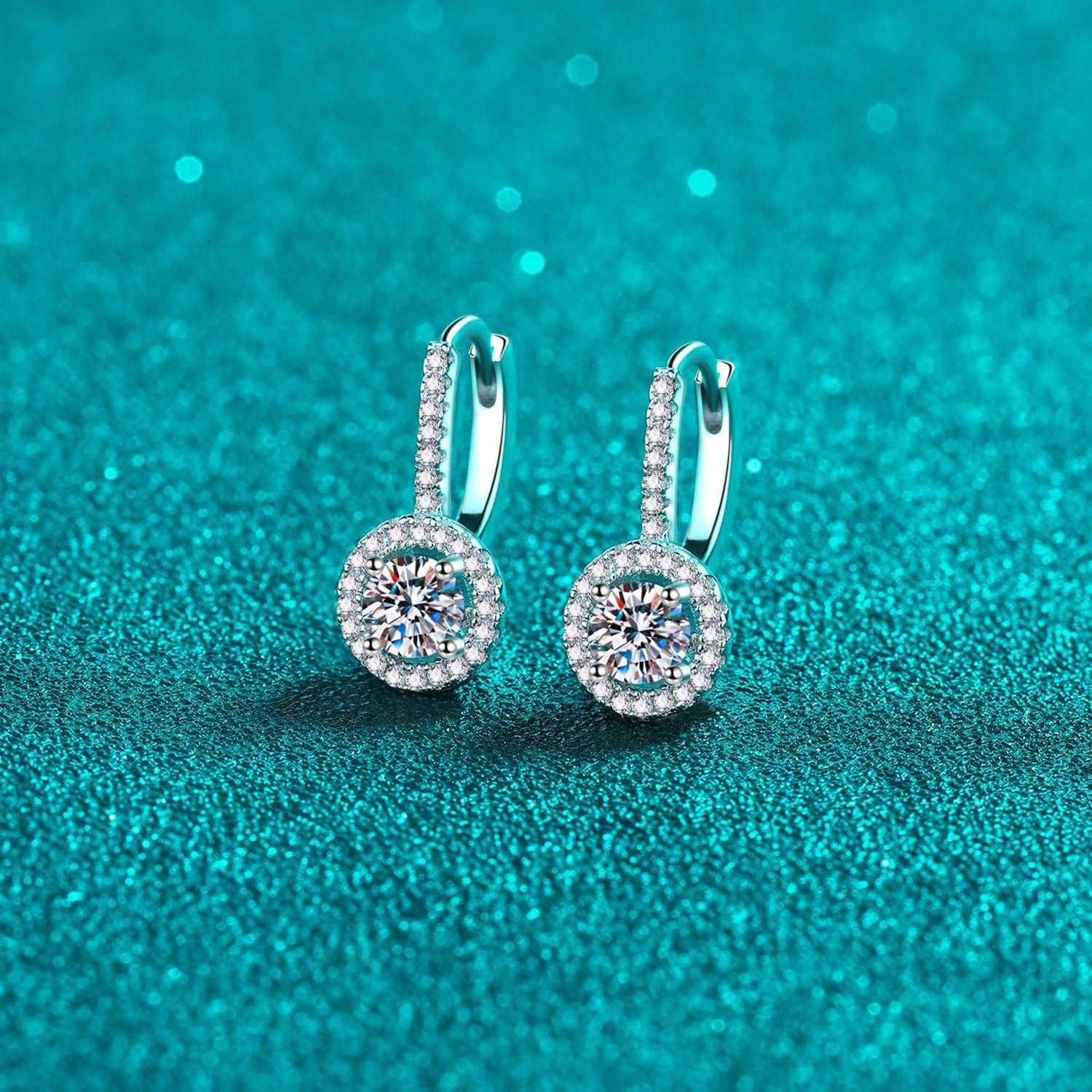 Elegant 1 Carat Moissanite Sterling Silver Earrings on Shimmering Teal Background