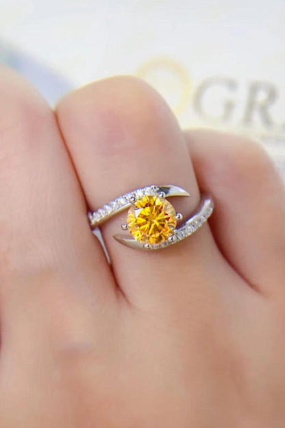 Sparkling yellow moissanite gemstone ring with pave diamond band on finger