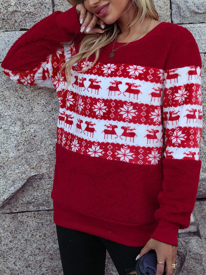 a woman wearing a red and white christmas sweater