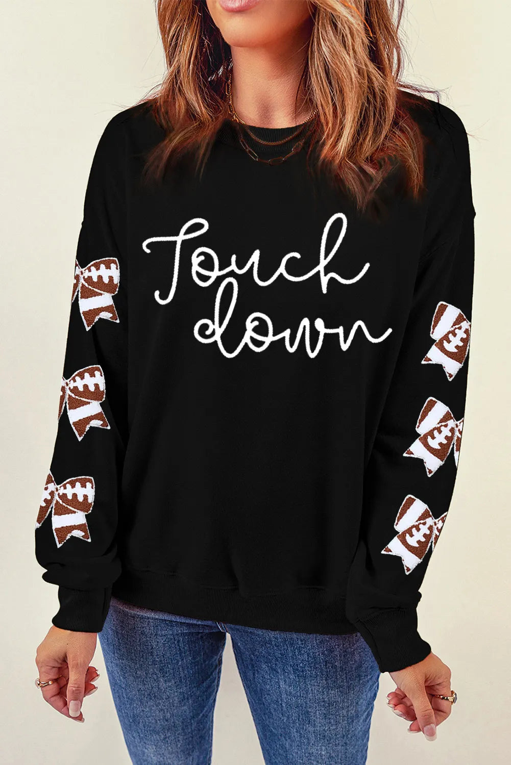 a woman wearing a black sweatshirt that says fowl down