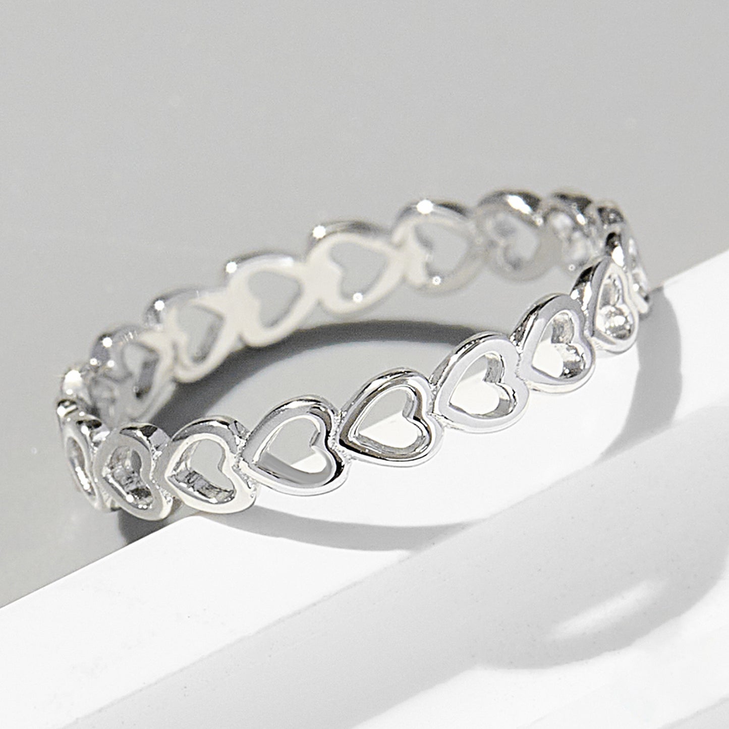 a silver bracelet with hearts on it