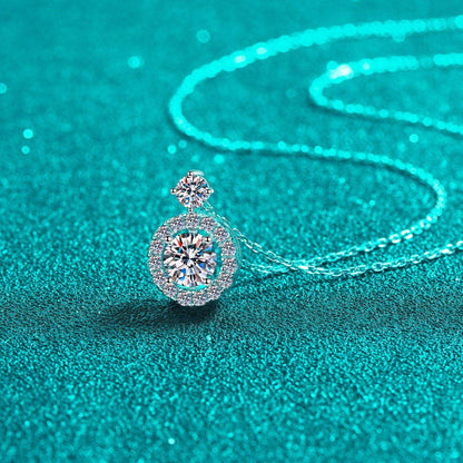 Elegant diamond pendant necklace on shimmering teal background