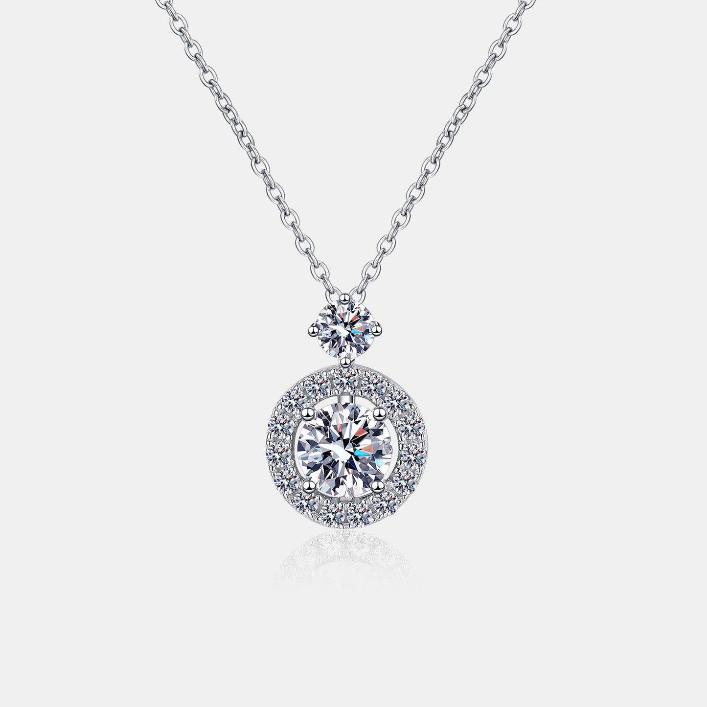 Elegant 1 carat moissanite and sterling silver necklace with a shimmering round pendant surrounded by a halo of sparkling crystals on a delicate chain.