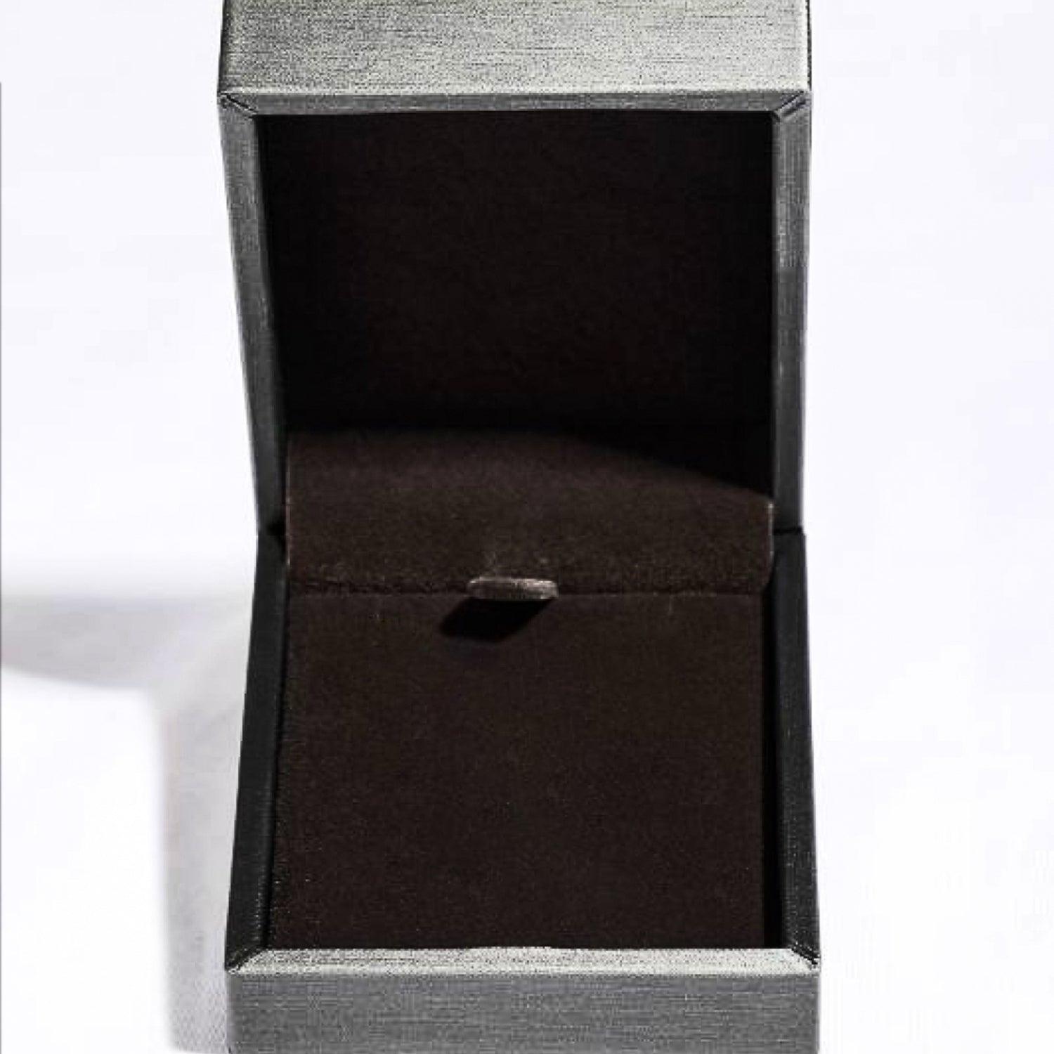 Sleek jewelry box in dark hues, showcasing a 1 Carat Moissanite 925 Sterling Silver Necklace from the Trendsi brand.